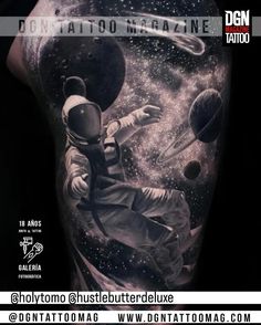 the back of a man's arm with an astronaut and planets on it