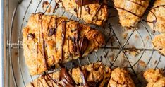 chocolate drizzled on top of scones sitting on a wire cooling rack