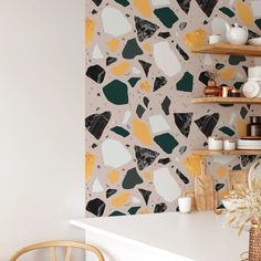 a white counter topped with shelves filled with dishes