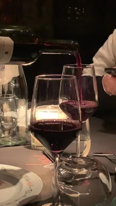 two glasses of wine are sitting on a table