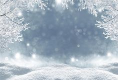 snow covered ground with trees and lights in the background on a winter day or christmas eve