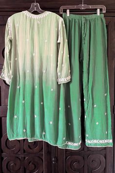 This comfy and beautiful Green Lucknowi Hand Embroidered Chikankari Short Frock A-Line Peplum Kurta Pant Set is perfect for any event. Handwork embroidery adorns the front, back, and sleeves, and a Croatia border lace adds a touch of elegance. Included wide-leg pants come with handwork embroidery and a convenient elastic waist band. 2 Piece Muslin Cotton Kurta length 36" inches Sleeves length 18" inches A line Bottom length 39" inches Elastic/drawstring waist Side-seam pockets Croatia border lac Chikankari Short Frock, Lucknowi Kurta, White Anarkali, Patiala Salwar Suits, Short Frock, Bridal Dupatta, Phulkari Dupatta, Kurta Pant Set, Border Lace