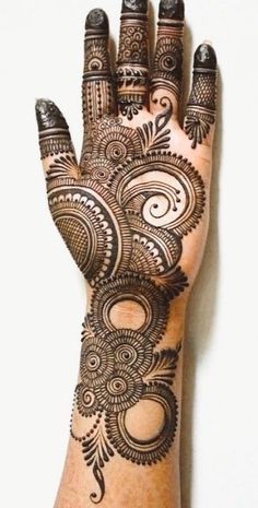 a hand with henna tattoos on it