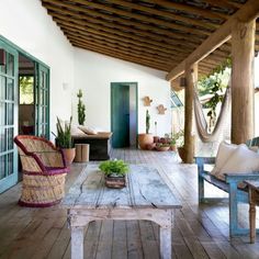 an outdoor living area with wooden floors and furniture