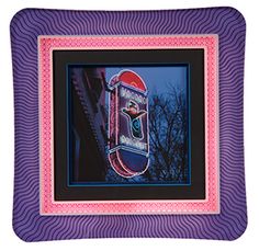 a pink and purple frame with a neon sign in the center on top of it