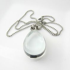 "A teardrop glass locket sways gracefully from a sterling silver ball chain necklace. The locket is encased in sterling silver and swivels from the bail , the contents can be seen from either side. The antique glass has a faint pale green cast, it's domed to highlight the treasure beneath. The pendant has a screw top closure, it opens by twisting the silver bead screw at the top. The locket and chain have been oxidized and buffed to highlight and add depth to the metal. Please note, the locket i Silver Teardrop Locket Necklace, Unique Locket, Push Gifts, Gold Locket Necklace, Sterling Silver Locket, Silver Locket, Glass Locket, Jewelry Lockets, Ball Chain Necklace