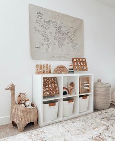 a white shelf with baskets and toys on it in a child's playroom