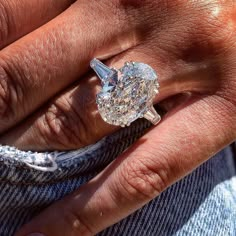 a close up of a person's hand with a ring on top of it