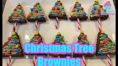 christmas tree brownies on a plate with candy canes and candies in the shape of trees