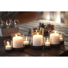 a group of candles sitting on top of a wooden table