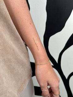 a woman with a small tattoo on her left arm and the word love is written in cursive writing