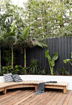 a wooden bench sitting on top of a wooden deck