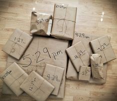 many wrapped presents are sitting on the floor with numbers and times printed on them in black ink