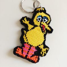 an embroidered key chain with a cartoon character on it