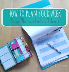 a binder and pen sitting on top of a wooden table next to a planner