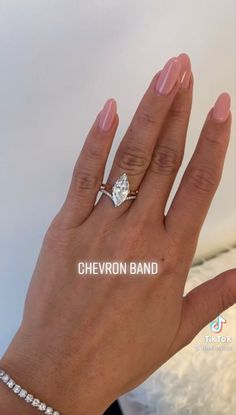 a woman's hand with a diamond ring on top of her left hand and the words, chevron band