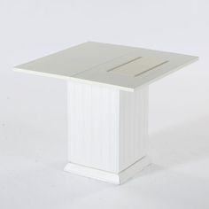 a small white table sitting on top of a white floor