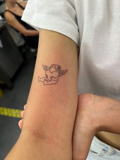 a person with a small tattoo on their arm