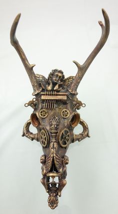 an animal's head with horns and mechanical parts on the face, against a white background