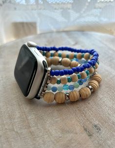 "Smart watch band made with stainless watch connectors consisting of 4 elastic beaded bracelets with blue quartz, blue glass beads and wood beads. Measures 5\" without device  COMPATIBILITY: For Apple Watch Series 8/7 (41mm) Series 6/5/4, SE (40mm) Series 3/2/1 (38mm) 20mm: for 20mm width of watch bands NOTE: Check the small line on the back of your watch to make sure you can choose the right model of the watch (38mm/40mm/41mm or 42mm/44mm/45mm/49mm), 20mm / 22mm / 24mm refers to width of the band, Please measure the width of the watch strap before you purchase it." Elastic Beaded Bracelets, Apple Watch Series 8, Blue Quartz, Apple Watch Band, Series 3, Apple Watch Series, Watch Strap, Apple Watch Bands, Wood Beads