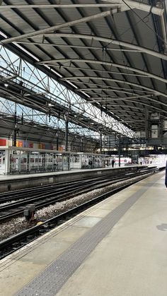 a train station with people walking on the platform