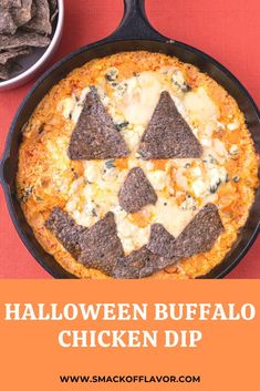 a pizza in a pan with the words halloween buffalo chicken dip on it next to chips