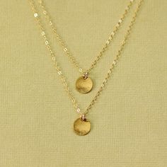 A double layered 14K Gold Filled necklace with hand hammered shimmer! Strung on sparkling 14K gold filled chain. Hammered Disc measures approx 11mm diameter. The chain lengths are 16 and 18 inches. Please note there is a single clasp for the necklace as shown! Hammered Disc measures approx 10mm diameter. The chain lengths are 16 and 18 inches. Please note there is a single clasp for the necklace as shown! Also available in sterling silver - simply select from the drop down menu. ► All NINA KUNA Gold Disc Necklace, Gold Disc, Hammered Sterling Silver, Jewelry Bag, Disc Necklace, Layered Necklace, Gold Filled Chain, Jewelry Bags, Chain Lengths