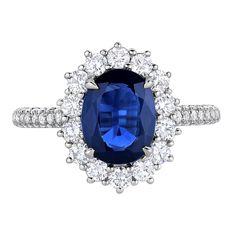 an oval shaped blue sapphire surrounded by round brilliant cut diamond halos in white gold