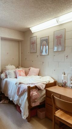 a bedroom with a bed, desk and pictures on the wall