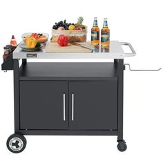 an outdoor bbq grill with drinks and food on it's side, ready to be used