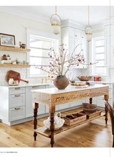 a wooden table sitting in the middle of a kitchen