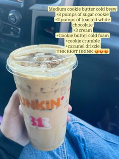 someone is holding up a drink in their hand and it has the words dunkin'kreme written on it