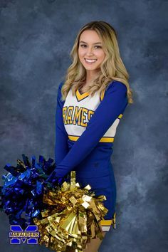 a woman in a cheer uniform holding a gold and blue pom - pom