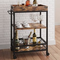 a bar cart with wine glasses and bottles on it