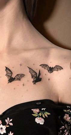 a woman's chest with bats and flowers on it