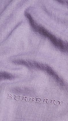 the burberry logo is embroidered on an unbuttoned purple shirt