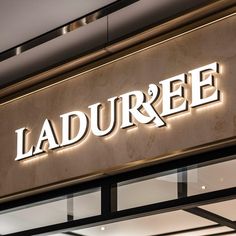 a sign that says ladurreee on the side of a building