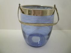 a blue and white striped bucket sitting on top of a table