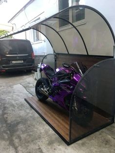 a purple motorcycle is parked in the garage