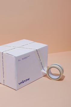 a white box with a tape on top of it