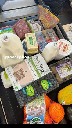 an assortment of food is displayed on a counter top with milk, eggs, and other foodstuffs