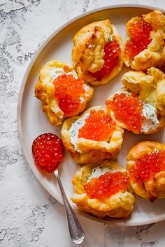 small pastries on a plate with raspberries