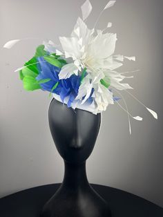 A white button base with a white feather crown, with bold lime green and periwinkle feathers, finished with pretty white vintage velvet flowers. Sits on a comfortable white headband. Lightweight and easy to wear. Ships in a high quality storage box. One of a kind.  Perfect for Kentucky Derby, Royal Ascot, church, weddings, just for fun. Fitted White Headpiece With Handmade Flowers, White Fascinator Headband With Handmade Flowers, Whimsical White Headband Headpiece, White Mini Hat Headband For Kentucky Derby, White Fascinator With Handmade Flowers, White Headband Mini Hat For Kentucky Derby, White Handmade Flowers Fascinator Headband, Whimsical White Headband, White Handmade Flowers Headpiece For Kentucky Derby