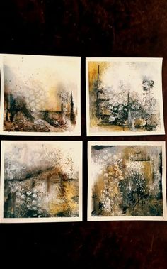 four paintings are shown on a table with black and white inks, one is yellow