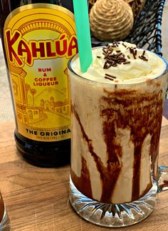 there is a drink with ice cream and chocolate on the table next to it's bottle