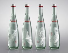 three bottles with different designs on them, one is empty and the other has an image of a bird