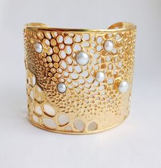 If you love gold statement jewelry big bold and gold cuff bracelets, this very special chunky style cuff is for you. Complete with our Keshi baroque pearls, bezel set and sparkly! We only make a few of these, so it's totally unique and when you wear it out, people are going to ask you where you got it. It's a statement piece and unique to this store. A great wedding bangle for the big day, or a perfect pearl anniversary or June birthstone gift. It's a super summery cuff for wearing with dresses and kaftans this summer too. Incredible maze like formations in coral patterns are the inspiration for this beautifully modern and unique Keshi Pearl gold cuff bangle, in 18kt gold plate and real Keishi pearls we handpick from the pearl farms in Lombok Indonesia, are lovingly dotted throughout.  Adj Gold Cuff Bracelets, Chunky Cuff Bracelet, Gold Cuff Bangle, Gold Statement Jewelry, Chunky Gold Bracelet, Bracelet Indian, Pearl Anniversary, Gold Pearl Bracelet, Indian Bangles