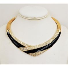 This is part of Chairish’s Costume Jewelry assortment.  Goldtone black enamel & Swarovski rhinestones v shaped collar necklace with fold over clasp. Marked "Napier." Measures: 6 1/2 inches long by 6 inches wide. Condition: Very good; minor surface wear to goldtone. Original retail price: $135. Made in 1987-88. An identical necklace is shown on pg. 619 of Melinda L. Lewis & Henry Swen's book "The Napier Co.: Defining 20th Century American Costume Jewelry."  Please reference the measurements noted Black Rhinestone Necklaces For Formal Occasions, Black Enamel Party Jewelry, Black Rhinestone Necklace For Formal Occasions, Gold-tone Costume Jewelry Necklace, Gold-tone Choker Style Costume Jewelry, Vintage Gold Rhinestone Necklace Gift, Gold-tone Costume Jewelry Choker, American Costume, Vintage Gold Metal Rhinestone Necklace