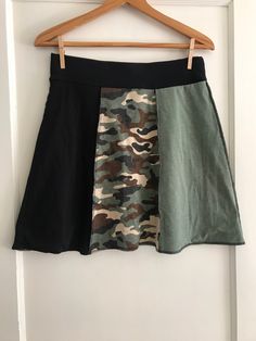 "Green and Brown Camo Skirt".  One-of-a-kind handmade skirt made from thoughtfully selected used T-shirts. Double layered for durability and comfort. Exposed seams for a funky look. Wearable art. Simply twist to change the look. Women's size 4-6. Waist 30" Waist 17" including 2" waistband. Machine Washable. Military Crafts, Yoga Skirt, Camo Skirt, Handmade Skirts, Travel Capsule Wardrobe, Exposed Seams, Travel Wardrobe, Green And Brown, Wearable Art