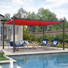 an outdoor patio with blue chairs and a red awning over the swimming pool area